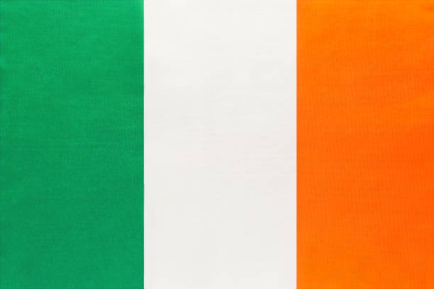 istock Ireland national fabric flag with emblem, textile background. 1174211853