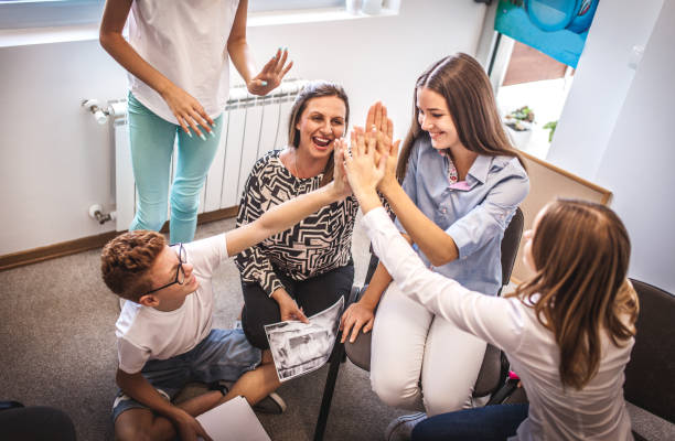 istock Happy mature teacher assisting school kids 1174214859