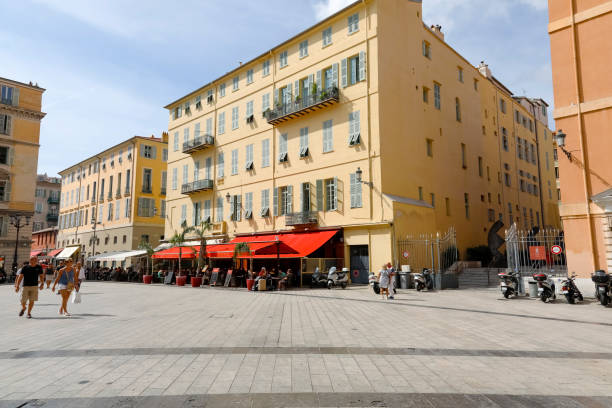 the sun illuminates tenement houses in nice. the city of nice is located on the french riviera in the provence-alpes-cote d'azur region - city of nice restaurant france french riviera imagens e fotografias de stock