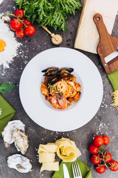 istock Pasta with king prawns on a gray background in a white dish. 1174223735