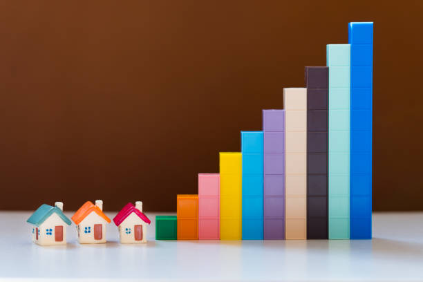 istock Miniature colorful house with growth graph 1174232562