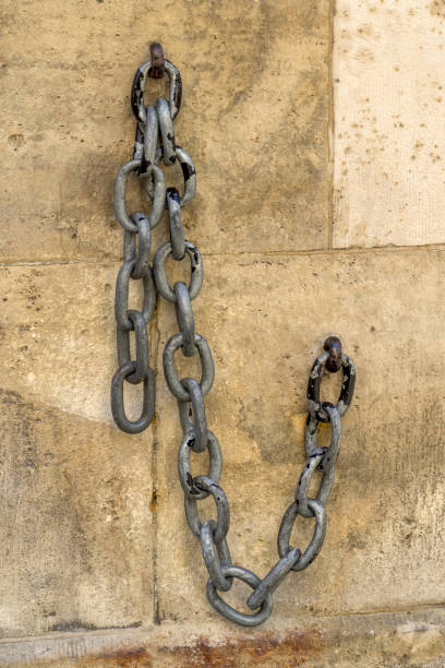 istock Old chain on the facade of a stone house... 1174234552