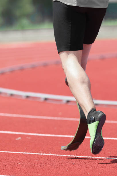 athlete with prosthesis on the leg athlete with prosthesis on the leg in the running track of sport venue paralympic games stock pictures, royalty-free photos & images