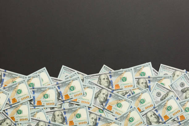 istock Top view banknotes on colored desk with copy space on top. one hundred dollar bills with stack of money in the middle. Top view of business concept 1174240559