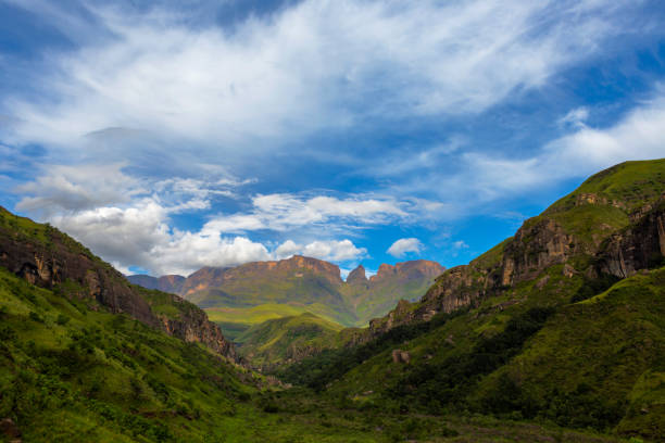 istock Green valley with clouds against the blue sky 1174240577