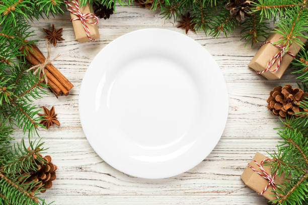 istock top view. Empty plate round ceramic on wooden christmas background. holiday dinner dish concept with new year decor 1174241325