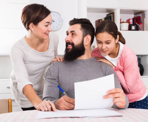 istock Parents signing property papers 1174242032
