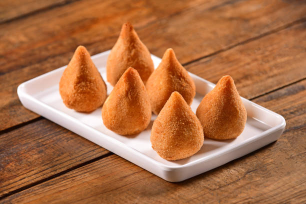 Brazilian Snack-Coxinha Coxinhas plate on wooden background coxinha stock pictures, royalty-free photos & images
