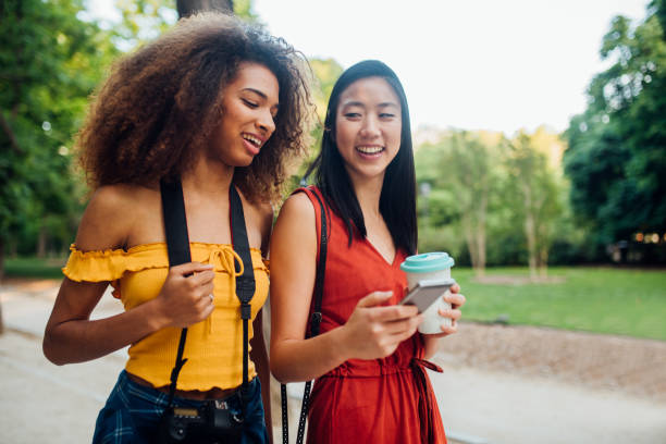 istock Mixed race girls walking through park 1174249665