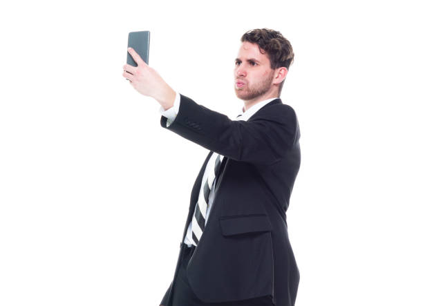 istock Handsome businessman wearing a black suit - is taking selfie 1174250042