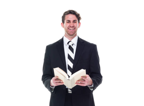 istock Good looking young businessman wearing black suit - holding book 1174250356