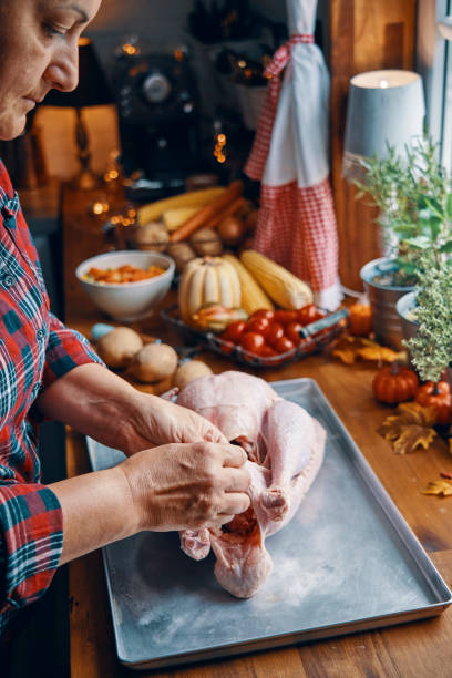 istock Preparing Stuffed Turkey for Holidays in Domestic Kitchen 1174250976