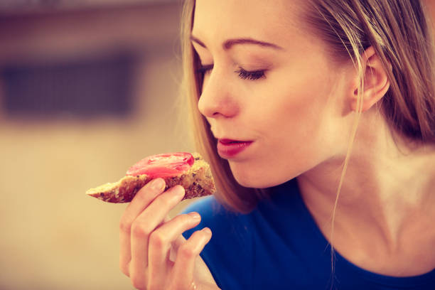istock Woman having healthy breakfast eating sandwich 1174252506