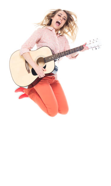 istock Beautiful female jumping - acoustic guitar 1174254428