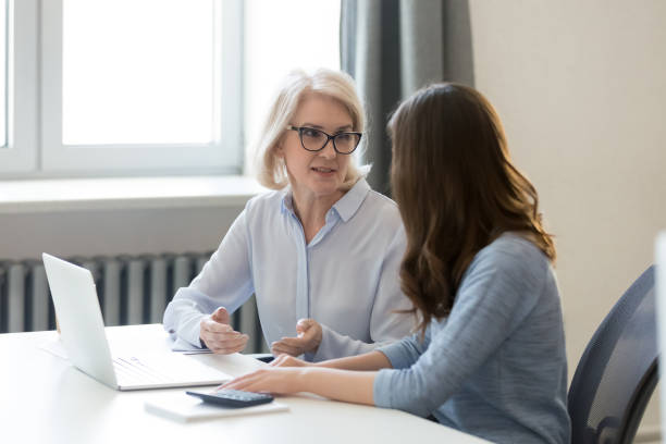 istock Female colleagues talk discussing project at workplace 1174254655