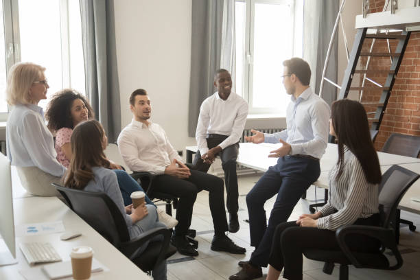 istock Multiethnic colleagues talk negotiating at informal office meeting 1174254726