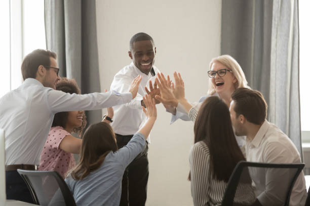istock Excited multiracial colleagues give high five motivated for success 1174254734