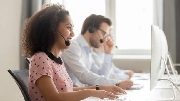 istock Smiling african American employee in headset consult client online 1174254766