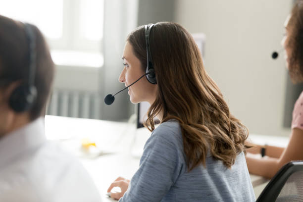 istock Millennial female employee in headset work in shared office 1174254773
