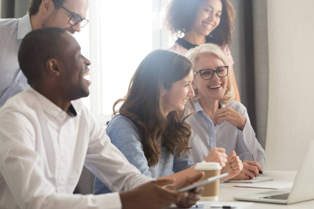 istock Smiling multiethnic employee laugh watching funny video on laptop 1174254810