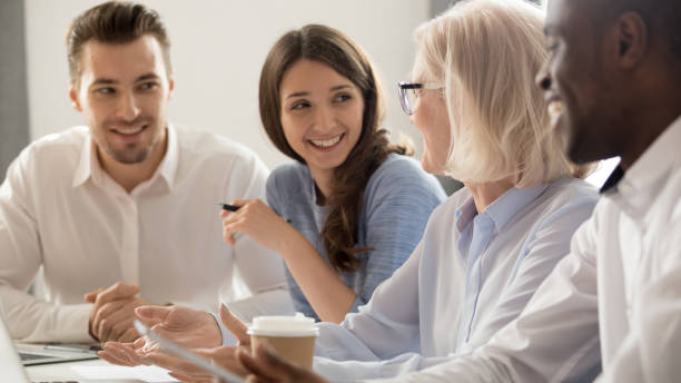 istock Smiling diverse employees have fun talking at coffee break 1174254813