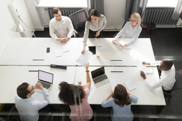 istock Top view of diverse employees analyze paperwork at office meeting 1174254831