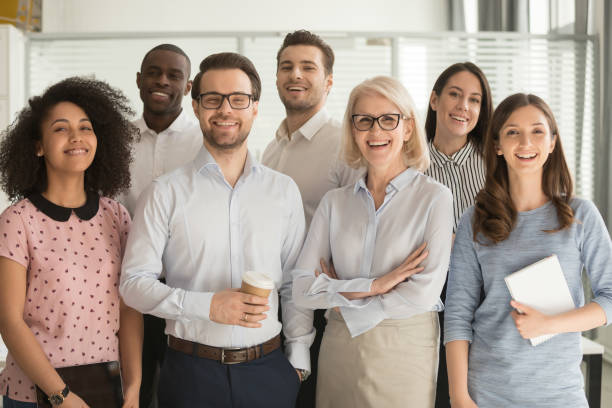 istock Smiling diverse employees posing for photo in office 1174254838