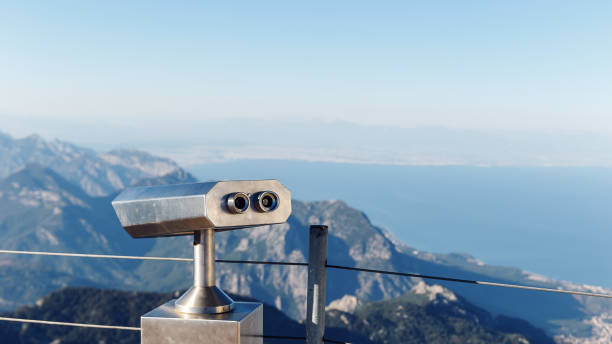 istock Stationary binoculars or binoscope on the viewing platform against the background beautiful landscape in the mountains. Lovely view of the Taurus Mountains and the Mediterranean coast. Kemer, Turkey 1174255088