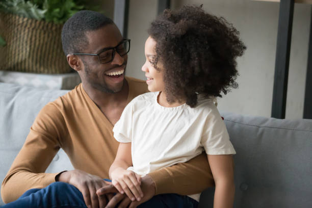 istock Happy black dad and daughter laugh talking at home 1174255223