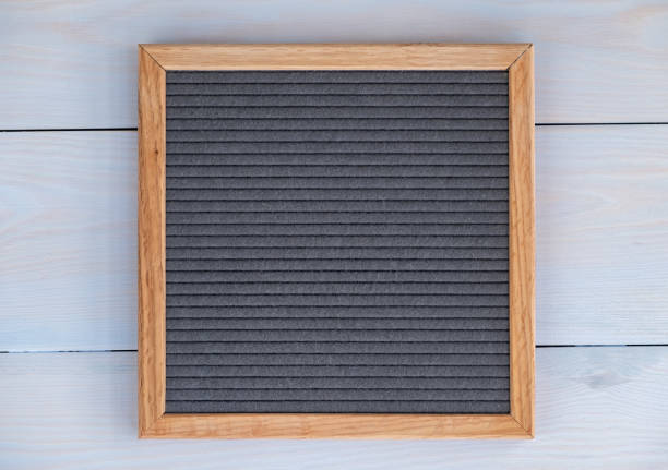 istock empty grey felt letterboard on natural wood background. procurement for design 1174255367