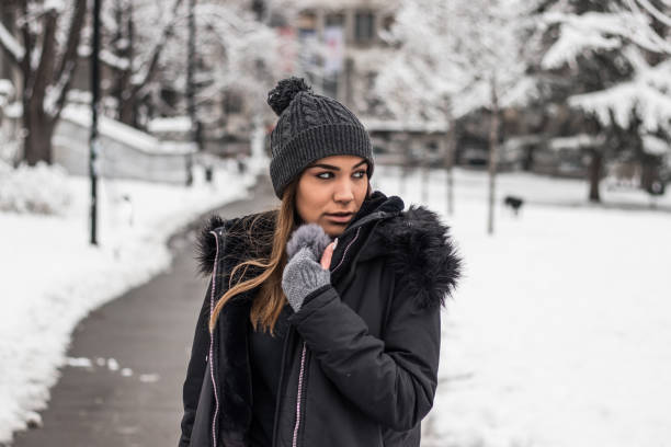 istock Pretty woman in park covered with snow 1174255471