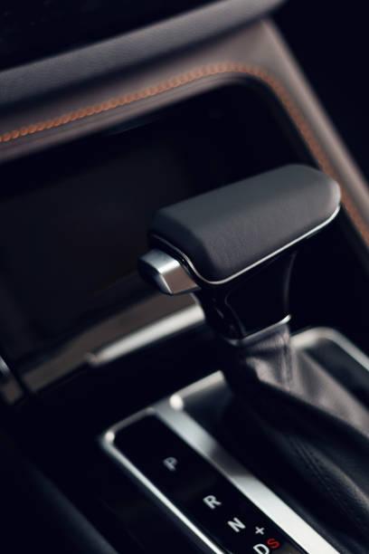 istock Selector automatic transmission with perforated leather in the interior of a modern expensive car. The background is blurred 1174255558