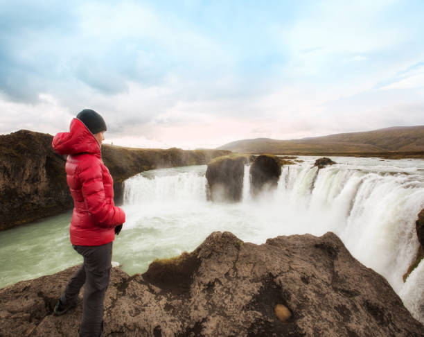 istock Woman at Godafoss Falls, Iceland - series 1174258806
