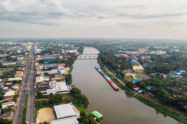 istock Cityscape with river with traffic on highway in countryside 1174259992