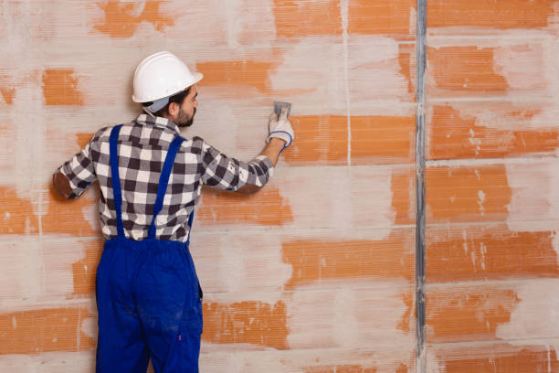 istock Workman is plastering the wall at the place 1174260507