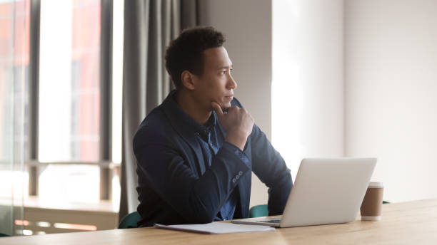 istock Mixed race entrepreneur sit at desk looking out the window 1174262742