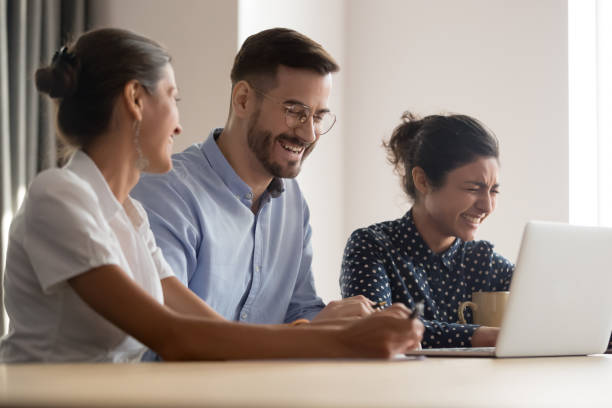 istock Diverse colleagues feels overjoyed laughing sit at workplace 1174262743