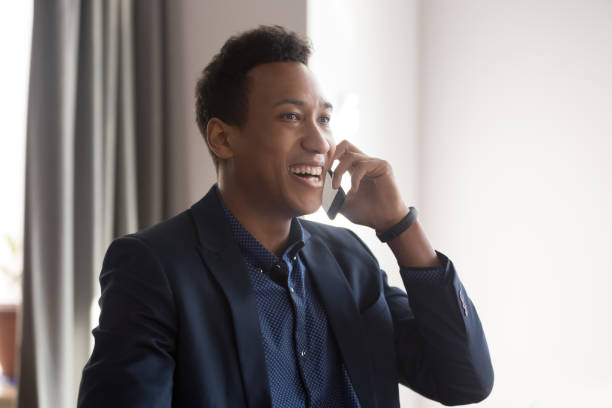 istock Cheerful mixed race businessman talking on mobile phone feels overjoyed 1174262765