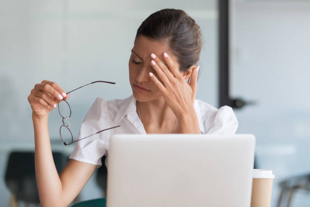 istock Millennial woman taking off glasses tired of computer work 1174262789