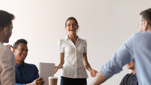 istock Diverse seminar participants and coach laughing during corporate training 1174262819