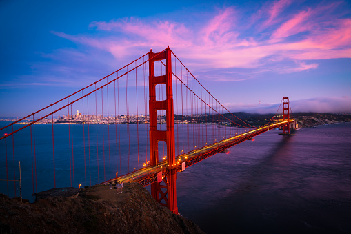 tourist travel destination the most popular icon of America - infamous suspension bridge during Once in a lifetime Golden Gate Bridge Sunset over San Francisco California