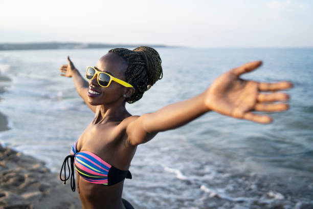 istock African woman having fun at beach 1174266763