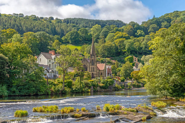 church from across a river. - dee river river denbighshire wales imagens e fotografias de stock