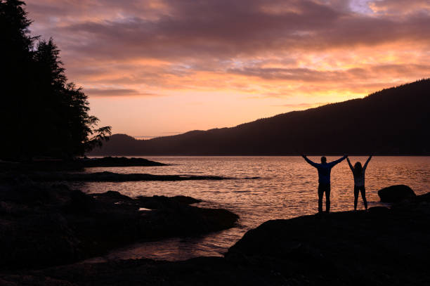 istock Silhouette couple celebrating at sunset 1174267362