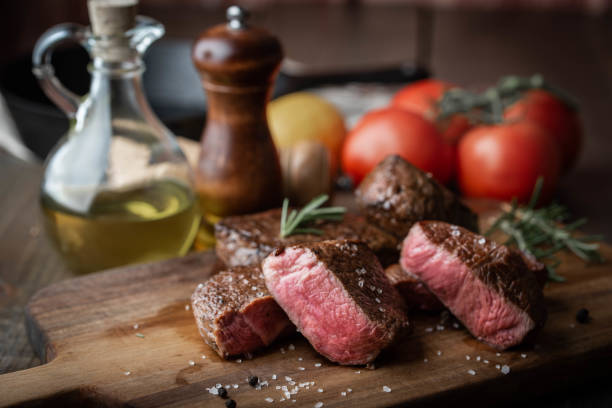 istock rare grilled tenderloin beef steak on cutting board with vegetables 1174267726