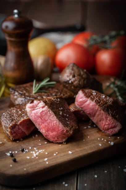istock rare grilled tenderloin beef steak on cutting board with vegetables 1174267961