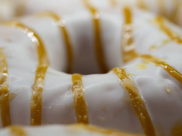 istock donuts poured with white glaze poured with strips of caramel 1174268834