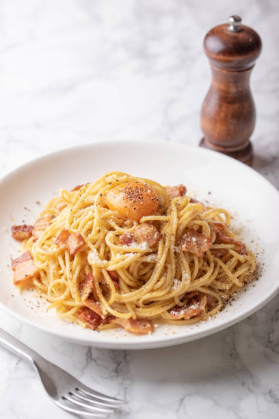 istock carbonara spaghetti with raw egg yolk on top 1174269317