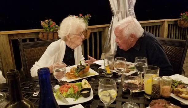 istock Active Senior Couple Enjoying Conversation Over Dinner at a Restaurant 1174271942