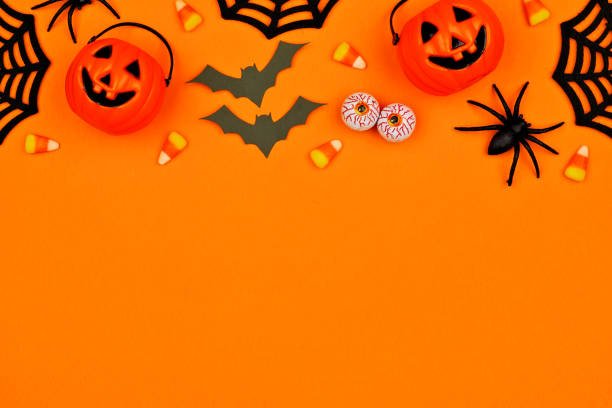 istock Halloween decor top border over an orange background with copy space 1174280174